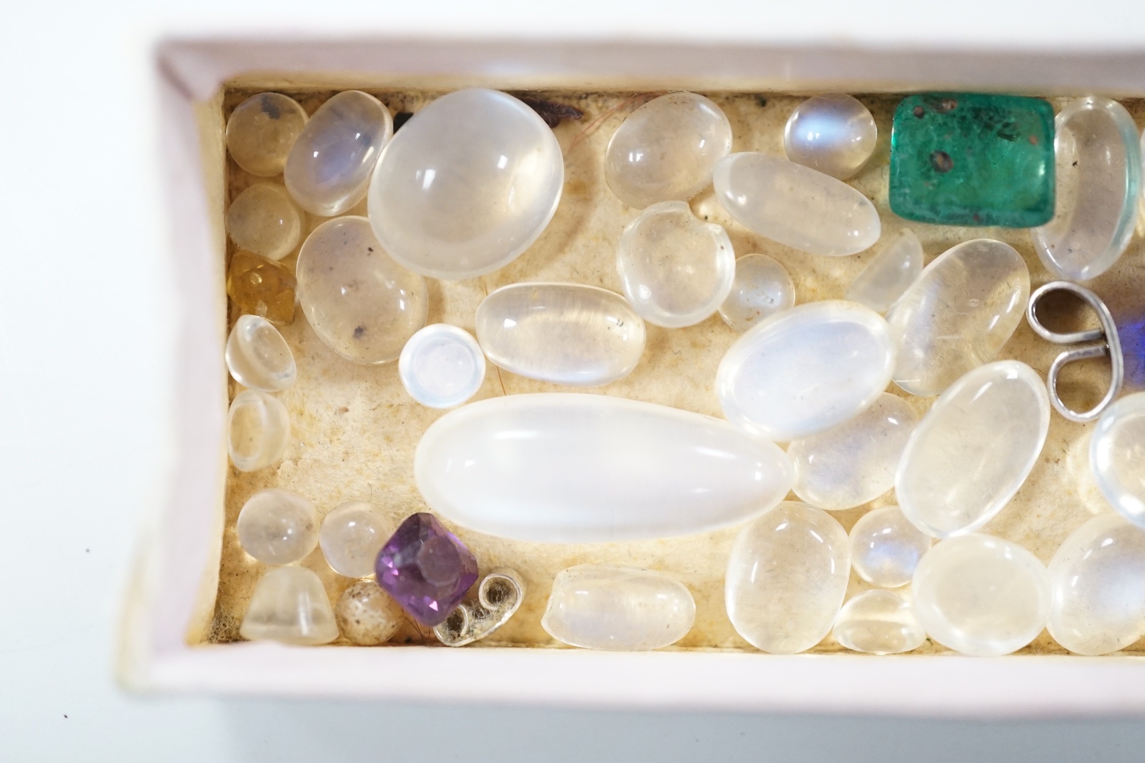 A small quantity of unmounted cabochon moonstones of varying sizes and four other unmounted coloured stones including green paste.
